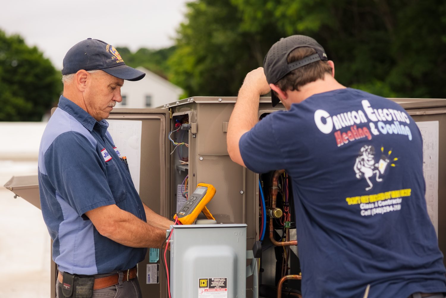 Callison HVAC technicians testing a rooftop system with a meter in Augusta County, Virginia